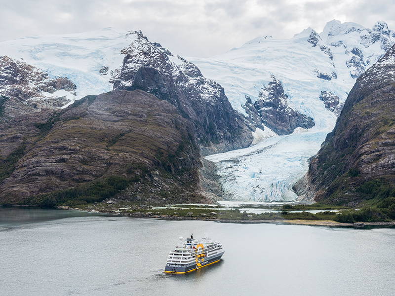 Ultramarine expedition cruise vessel approaching a glacier in Patagonia.
