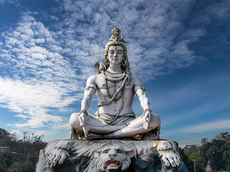 Lord Shiva statue on the banks of the sacred Ganges River in Rishikesh, India.