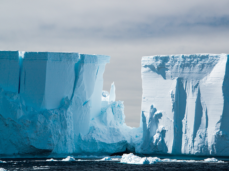 Raking light on a blue white floating tabular iceberg in the Weddell Sea 